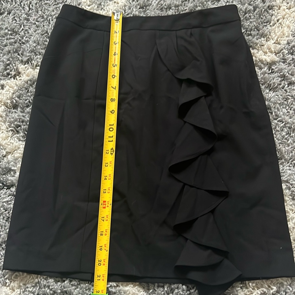 Black skirt with front ruffle.